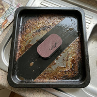 Oven tray half cleaned with SPONJ