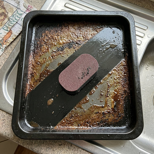 Oven tray half cleaned with SPONJ